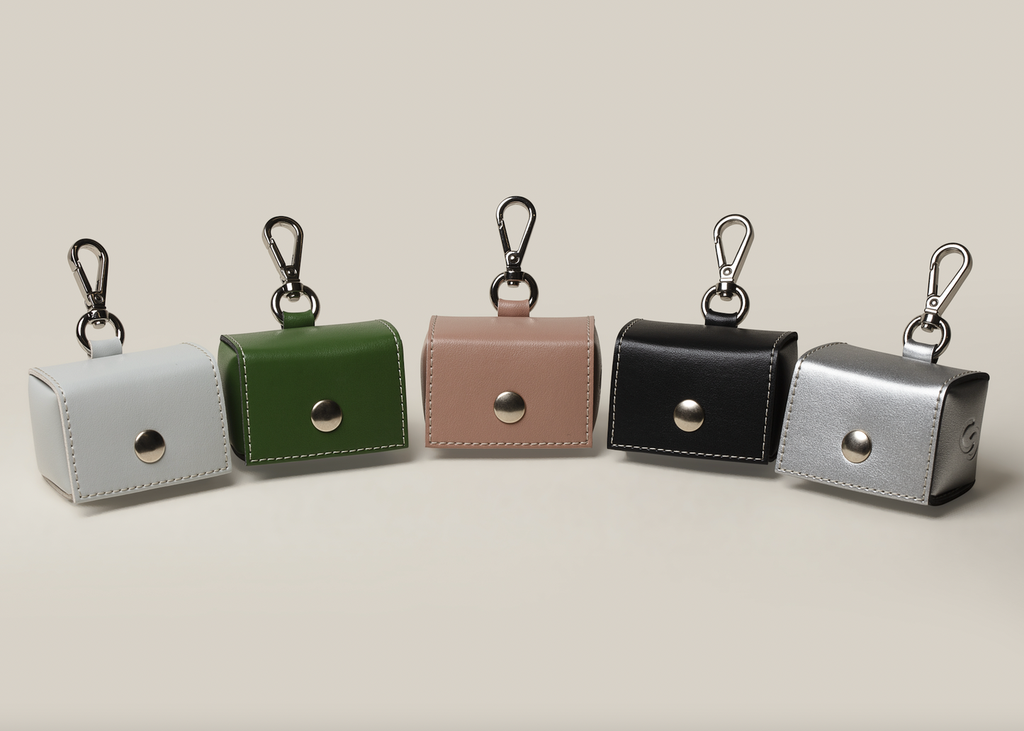 Skylos Collective apple leather poop bag holders. Made in UK available in blush pink forest green ice blue black and silver